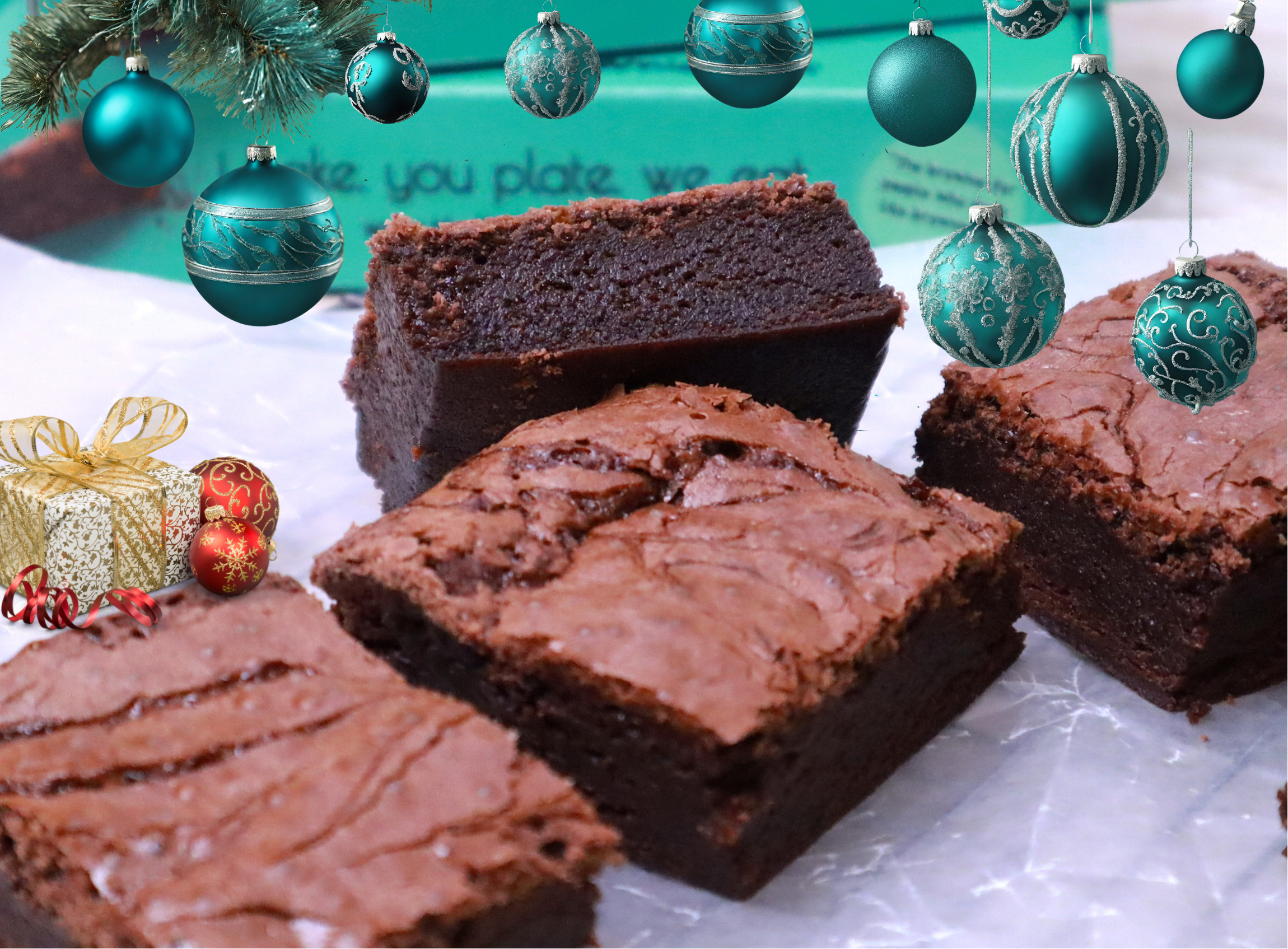 Chocolate brownies with Christmas decorations on a white surface